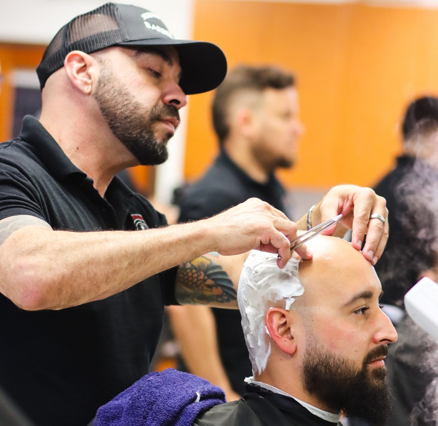 Instructor shaving a customer's hair